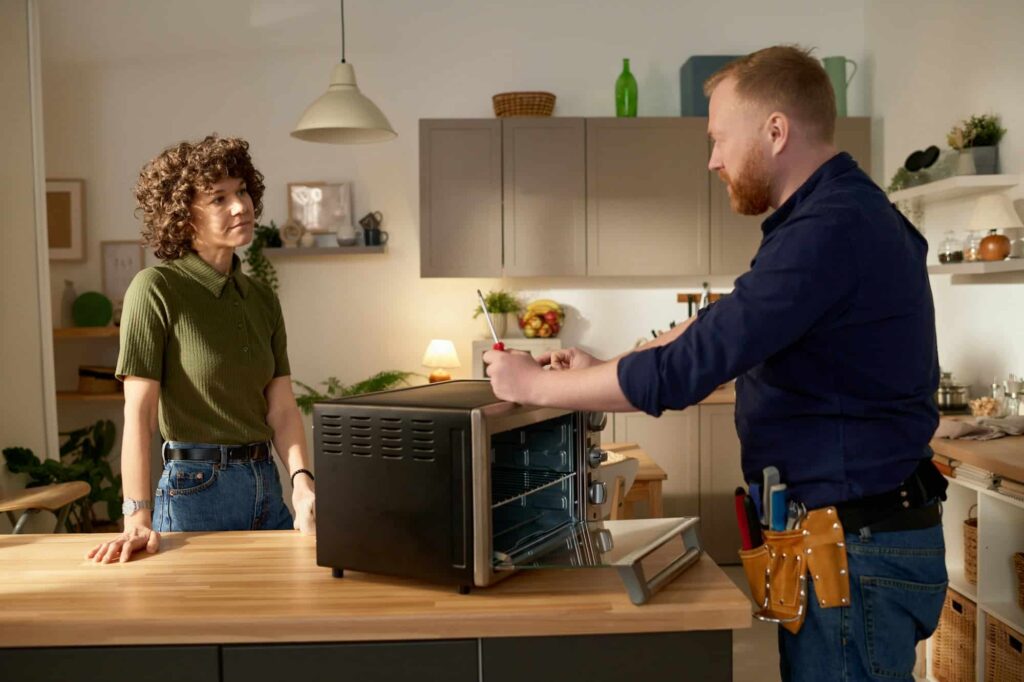 man repairing broken microwave at home.jpg